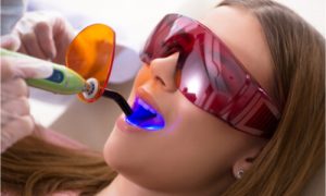 The dental professional uses modern technology to improve dental treatment.